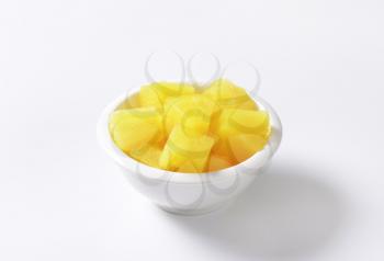 Bowl of pineapple pieces in light syrup