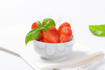 Bowl of halved fresh egg-shaped tomatoes
