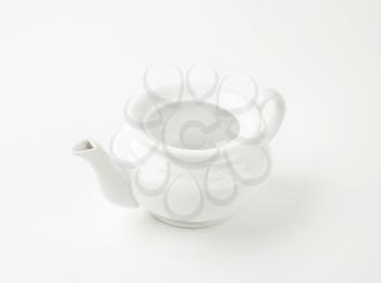 Empty white porcelain teapot without a lid