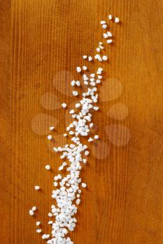 Coarse grained salt on wooden table