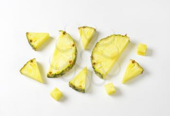 Fresh pineapple slices and wedges - studio shot