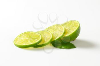 Slices of fresh lime on white background