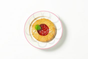 Single whole wheat Linzer cookie filled with red currant preserve