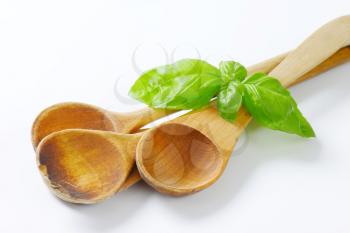 three old wooden spoons on off-white background