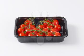 fresh cherry tomatoes in black plastic container
