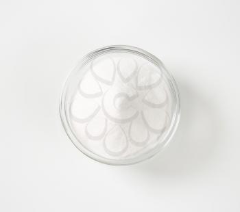 bowl of sodium bicarbonate on white background