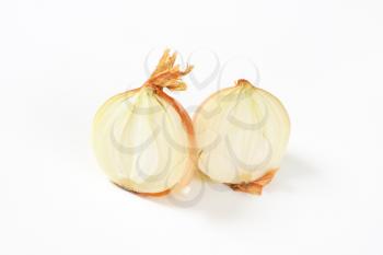 halved raw onion on white background