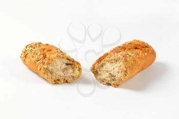 halved bread roll topped with seeds