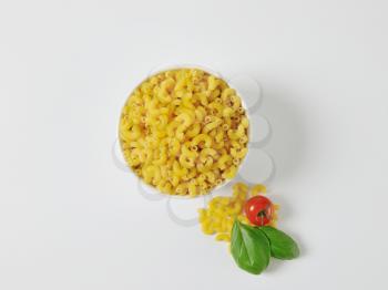 Heap of uncooked macaroni in a bowl