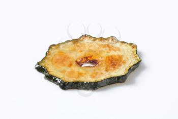 thin slice of roasted zucchini on a white background
