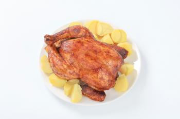 Dish of marinated roasted chicken and boiled potatoes
