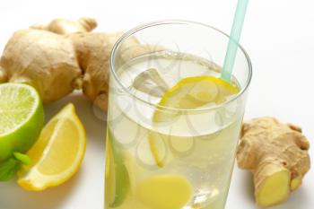 glass of homemade ginger ale with lemon, lime and ice