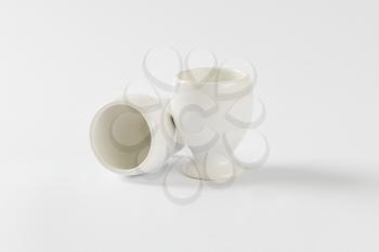 Two empty white porcelain egg cups