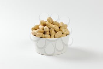 Bowl of raw unshelled peanuts