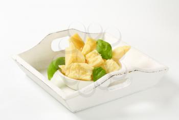 Pieces of Parmesan cheese in a tray