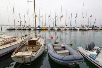 Sailing boats anchoring in marina in Lago di Garda, Italy