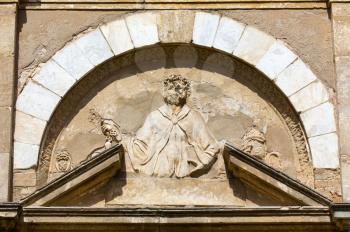 Relief on the front facade of the Church of San Pietro in Selci in Volterra, Tuscany, Italy