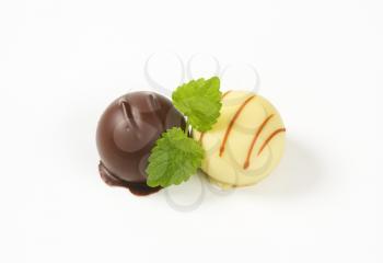 two belgian chocolate pralines on white background