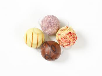 assorted belgian chocolate pralines on white background