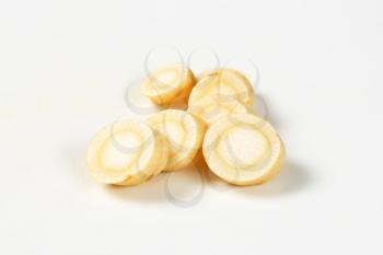 sliced parsley root on white background