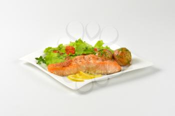 pan seared salmon fillet served with roasted potatoes and fresh vegetables