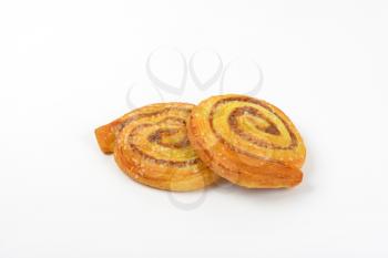 two sweet cinnamon rolls on white background