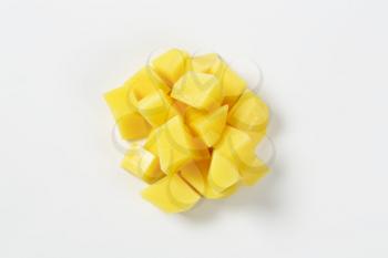 heap of diced potatoes on white background