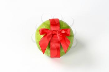 red ribbon bow on fresh green grapefruit