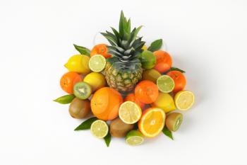 assortment of fresh tropical fruit on white background