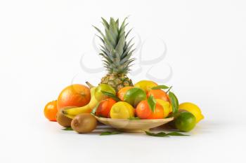 plate of fresh tropical fruit on white background