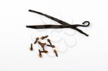 vanilla pods and cloves on white background