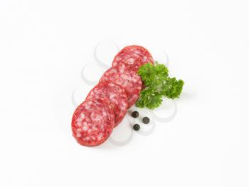 Slices of sausage salami on white background