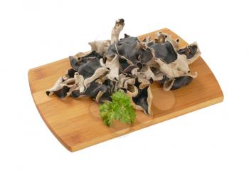 Air dried wood ear mushrooms on cutting board