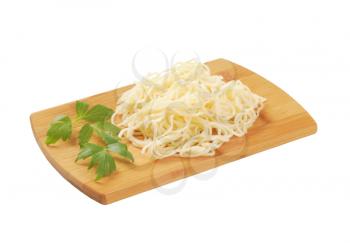 cooked thin noodles on cutting board