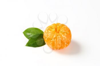 peeled seedless tangerine on white background