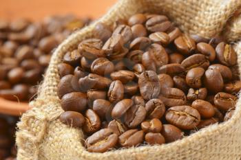 roasted coffee beans in burlap sack