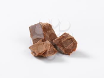 pieces of milk chocolate on white background