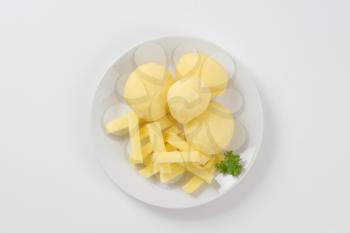 raw whole and chipped potatoes on plate
