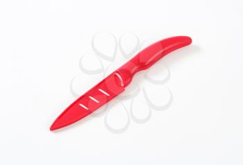 red ceramic kitchen knife on white background