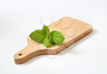 fresh mint leaves on wooden cutting board