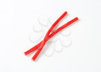 two soft and chewy red candy sticks with a fondant centre