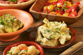 bowl of assorted pickled vegetables on wooden background - close up