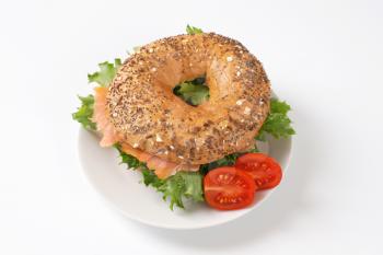 bagel sandwich with smoked salmon on white plate