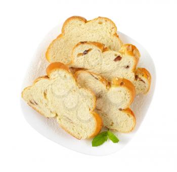 slices of Christmas sweet braided bread with almonds and raisins