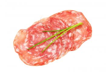 thin slices of dry salami and chives on white background
