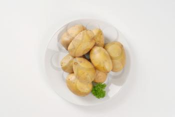 raw unpeeled potatoes on plate