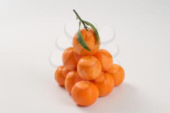 stack of fresh tangerines on white background