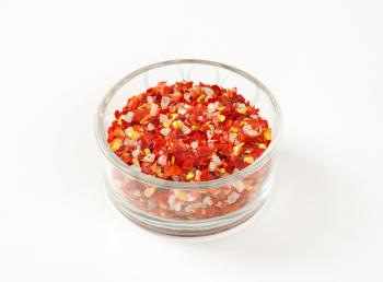 bowl of dried pepper and salt on white background