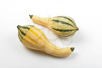 two small striped pumpkins on white background