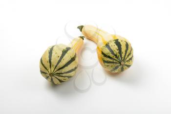 two small striped pumpkins on white background